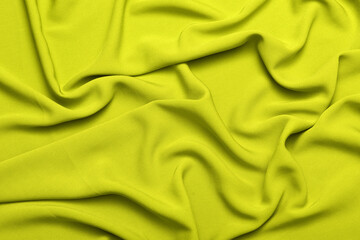 Soft lightweight flowy georgette fabric in kiwi green, elegantly draped with natural folds. Perfect for fashion design, textiles, sewing, dressmaking, and delicate feminine style concepts.