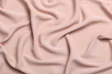 Soft lightweight flowy georgette fabric in pastel orange, elegantly draped with natural folds. Perfect for fashion design, textiles, sewing, dressmaking, and delicate feminine style concepts.