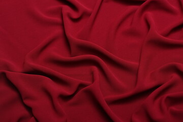 Soft lightweight flowy georgette fabric in dark orange, elegantly draped with natural folds. Perfect for fashion design, textiles, sewing, dressmaking, and delicate feminine style concepts.