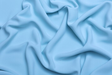 Obraz premium Soft lightweight flowy georgette fabric in pastel light blue, elegantly draped with natural folds. Perfect for fashion design, textiles, sewing, dressmaking, and delicate feminine style concepts.