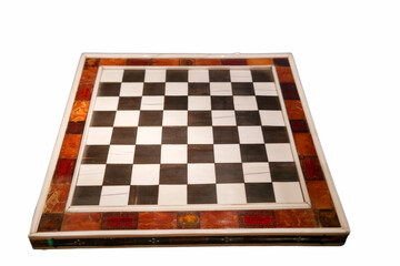 Elegant chessboard crafted from various materials displayed on a clean surface ready for a strategic game