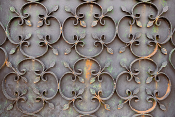 Close-up of a repeating pattern of stylized leaves on an old wrought iron gate, showcasing traditional craftsmanship and adding a touch of vintage charm in Valença do Minho, Portugal
