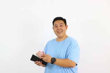 Man holding money and wallet smiling at camera