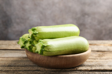 Fresh ripe zucchinis on wooden table, closeup