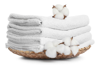 Stack of folded terry towels with cotton flowers isolated on white