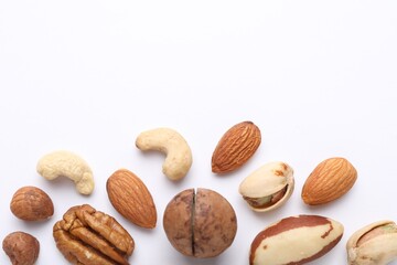 Mix of different nuts on white background, flat lay. Space for text