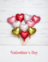 Heart-shaped balloons cluster on a white wooden background