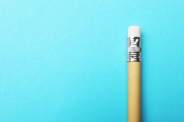 One graphite pencil on light blue background, top view. Space for text