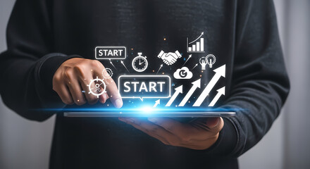 Businessman launching a new project or startup using a futuristic tablet with holographic business icons.