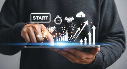 Businessman using a tablet to launch a new project with a digital interface showing growth charts and business icons.