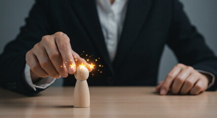 Professional awarding top star rating to wooden figure, symbolizing excellence and achievement in business.