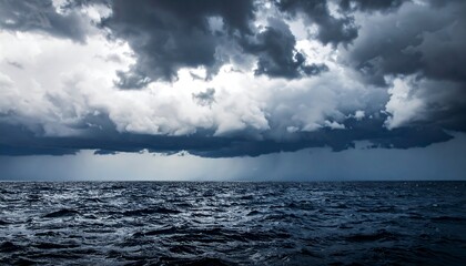Dark sea surface with a dramatic cloudy sky above, approaching storm