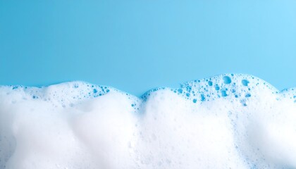 Detergent foam bubble on blue background, soap, shower gel, shampoo foam texture, copy space