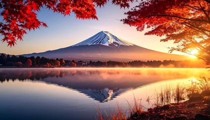 Tableau sur plexiglas Réflexion A serene landscape at dawn, showcasing Mount Fuji reflected in a tranquil lake, framed by vibrant autumn foliage.  © lord