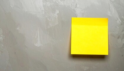 Yellow sticky note on gray textured surface