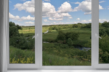 Fototapeta premium View from the window on the garden green trees. 