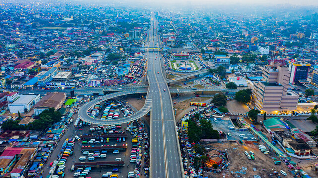 Ghana Accra, Aerial view of a bustling urban area with a major highway and traffic interchange.