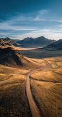 Naklejka premium Aerial View of Desert Road Winding Through Mountains