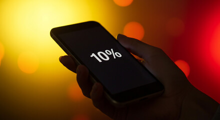 Hand holding smartphone with ten percent discount on the screen display