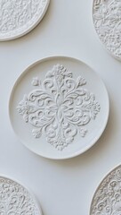Elegant white plates with ornate embossed floral designs