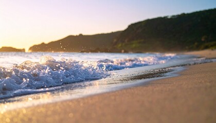 Fototapeta premium Golden hour sunlight washes over a tranquil beach with gentle waves lapping at the shore, creating a serene coastal landscape