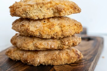 Fluffy homemade perrunillas, a typical Spanish cookie, are displayed on a wooden board against the cool marble background. Delicious and healthy!