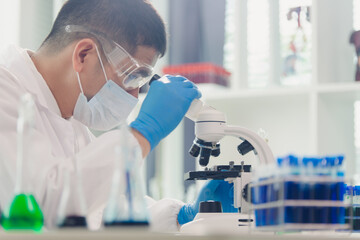 medical or scientific researcher researching and experimenting Multi-colored solution, vial and...