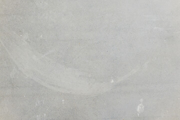 Smooth gray concrete surface with subtle textures and marks on it