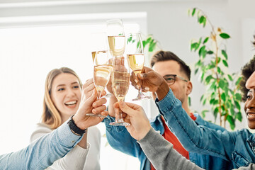 A portrait of young businesspeople or friends celebrating business success with a tost  in the office or young people having a party, teamwork and togetherness and having fun and friendship concept