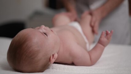 Gentle infant massage in a calm environment promotes relaxation and strengthens the bond between parents and baby