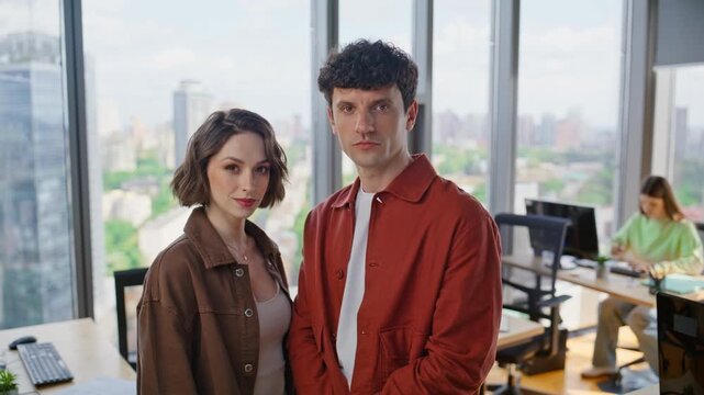 Confident people posing coworking windows background portrait. Startup partners