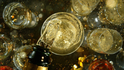 Freeze motion of pouring champagne into flute. Concept of celebration and success.