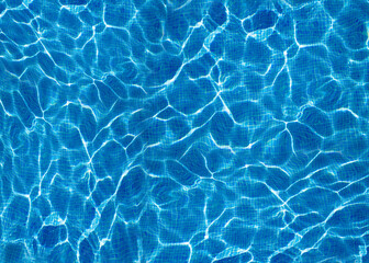 Close-up view of rippling blue water with sunlight reflections on a swimming pool surface