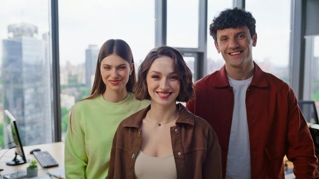 Startup team posing camera in panoramic windows office portrait. Business people