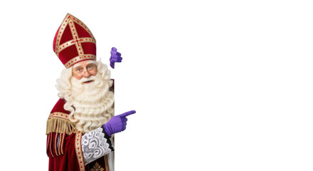 Elderly caucasian Sinterklaas with long white beard, opulent red and gold robe, purple gloves, peeking from large white sign, pointing to copy space, gentle studio portrait concept for holiday