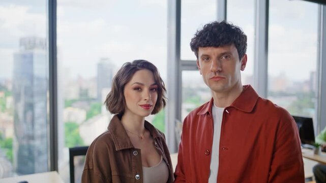 Two creative specialists posing in panoramic window portrait. Colleagues couple