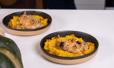 Fresh pumpkin puree served in elegant bowls with chicken and cranberries, showcasing a healthy autumn dish that highlights natural flavors and organic ingredients with copy space