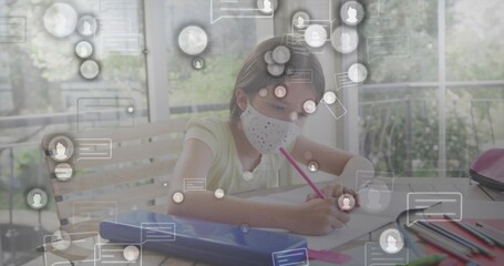 Drawing schoolgirl wearing face mask using pink pencil at home learning area, with digital icons
