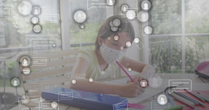 Drawing schoolgirl wearing face mask using pink pencil at home learning area, with digital icons
