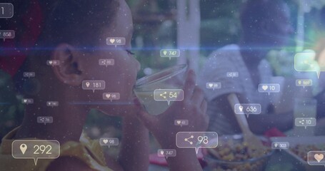 Child in yellow shirt drinking juice at kitchen table, with glass and social icons, copy space