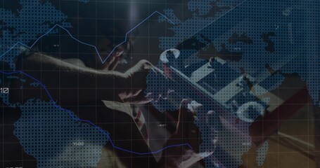 Holding tablet in suit and tie examining financial overlays in office, world map grid, trend arrow