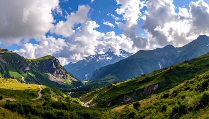 Fototapeta premium A breathtaking vista of a mountain valley, showcasing lush green slopes, winding roads, and towering peaks under a vibrant sky filled with puffy clouds.