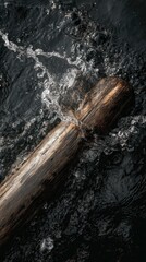 Dark wood log in water splash