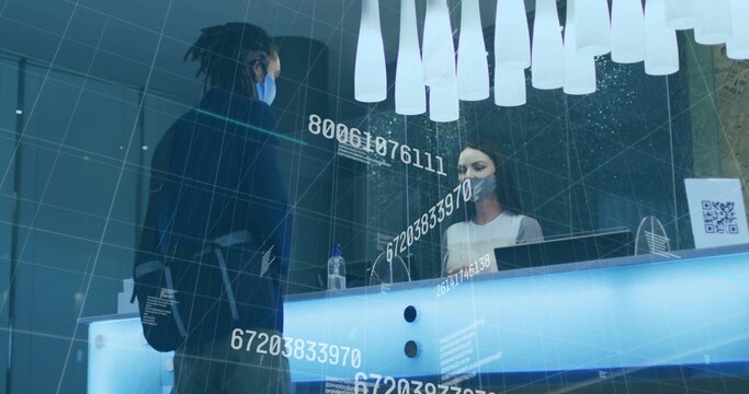 Talking masked man carrying backpack at front desk, with receptionist behind partition, copy space