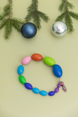 Christmas Medical Instruments with Christmas Tree and blue and silver balls on yellow, Khaki, green Background. New Year's photo of a medical hammer, orchidometer, tuning fork, stethoscope