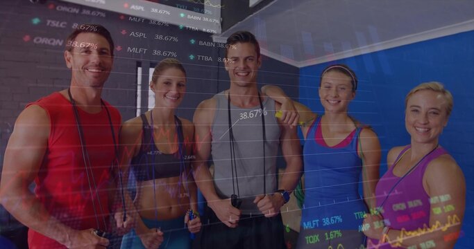 Fototapeta Standing five fitness members holding jump ropes in fitness studio, with financial chart overlay