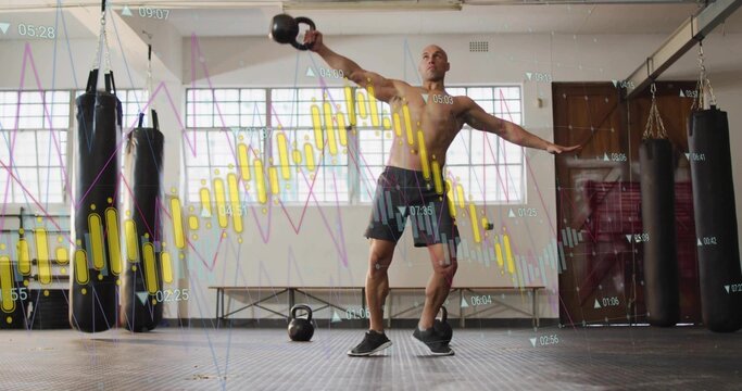 Fototapeta Swinging kettlebell shirtless athlete performing exercise in gym with punching bags, chart overlay