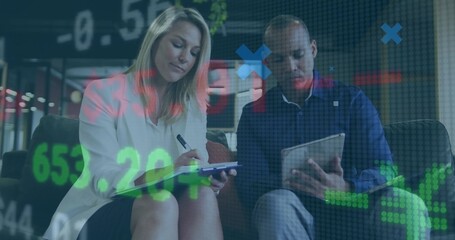 Analyzing financial charts overlay, coworkers sitting in workspace lounge with tablet clipboard pen