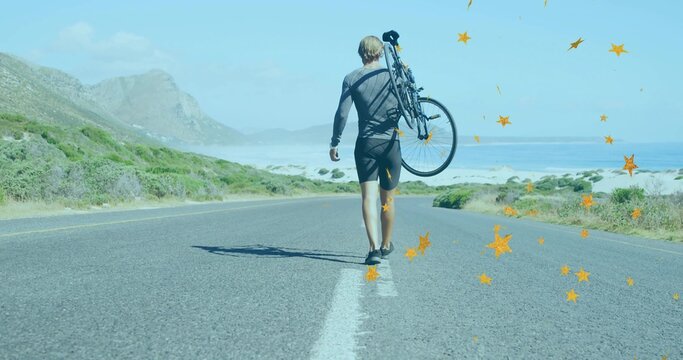 Walking male cyclist carrying bicycle over shoulder along coastal highway, wearing cycling outfit - Powered by Adobe