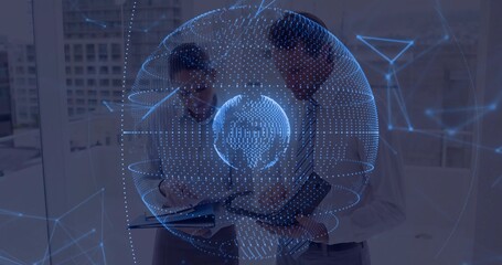 Analyzing holographic globe network in modern office, colleagues standing with tablet notebook pen